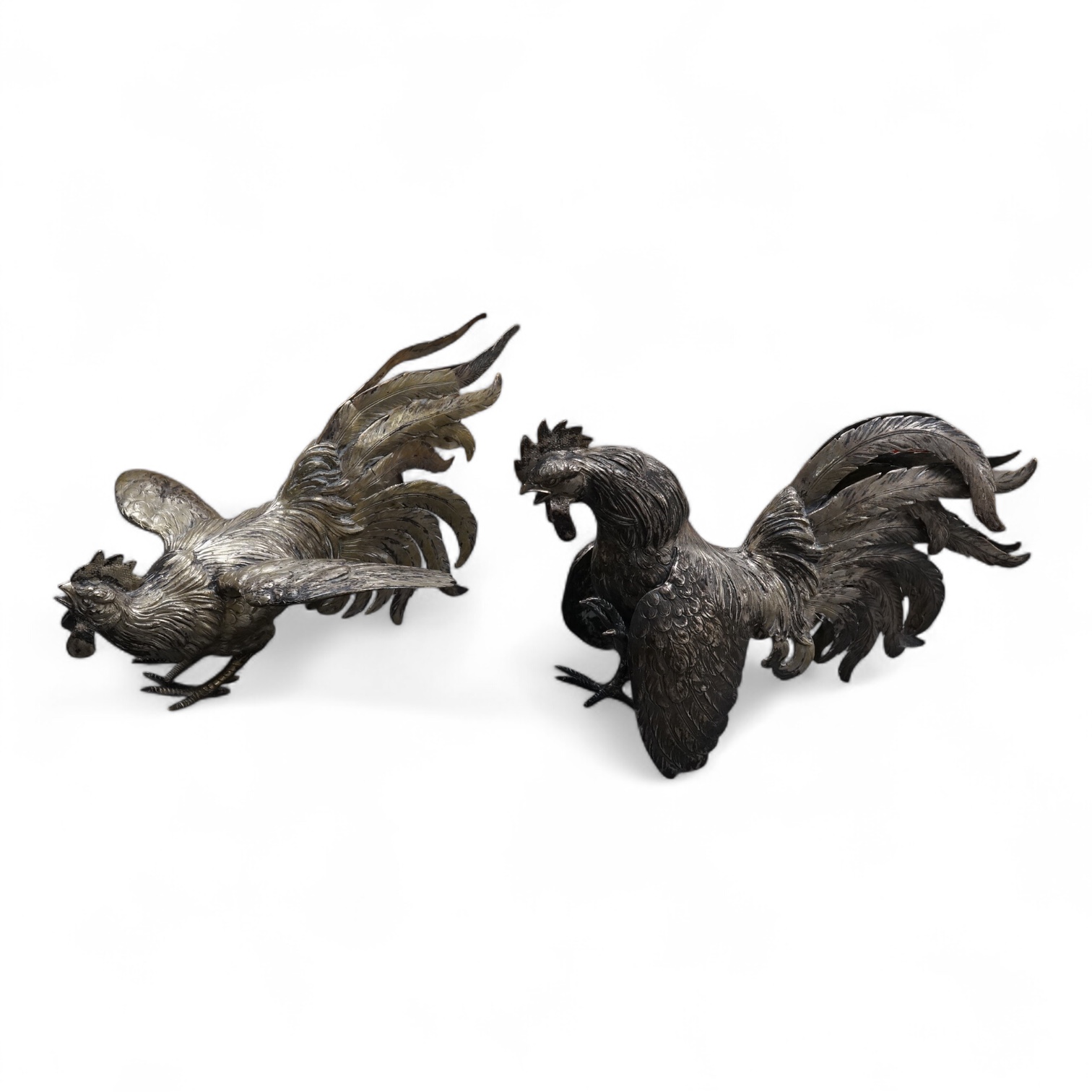 A pair of continental 800 standard white metal free-standing model fighting cockerels, tallest 16.6cm, 32.8oz.